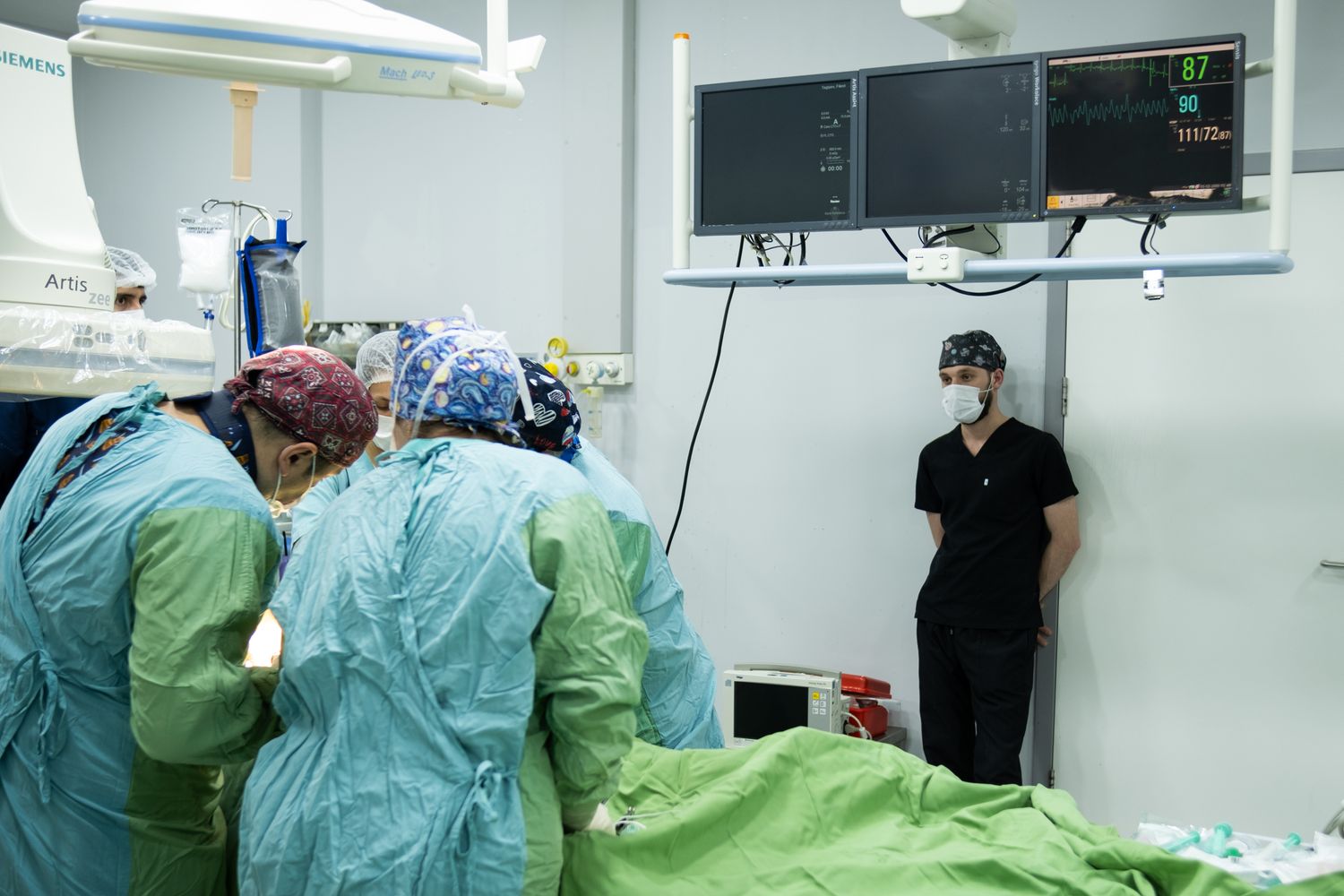 A clinical team and monitoring equipment in an operating room